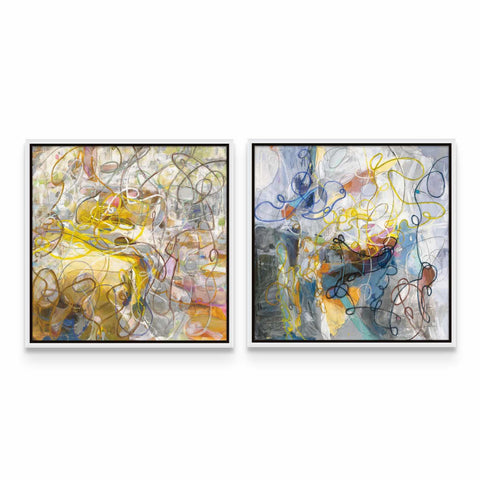 a couple of paintings sitting on top of a white wall