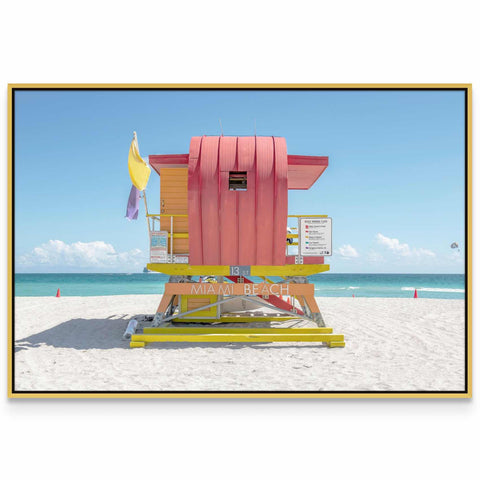 a lifeguard stand on a beach with a blue sky in the background