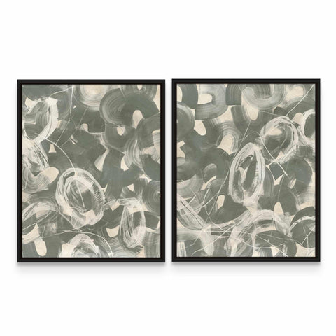 two framed paintings of black and white circles