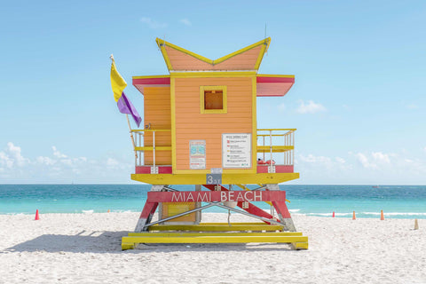 a lifeguard tower on the beach with a life guard flag