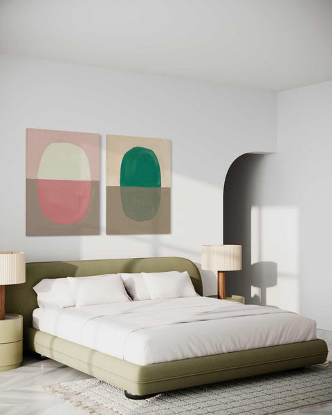 a bedroom with a large bed and two paintings on the wall