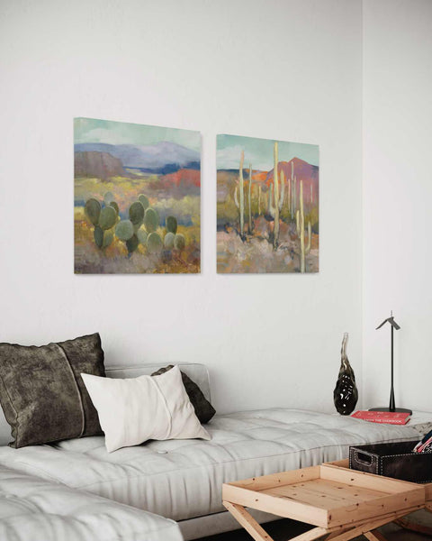 a living room with a couch, coffee table and paintings on the wall