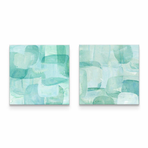 two paintings of blue and green shapes on a white wall