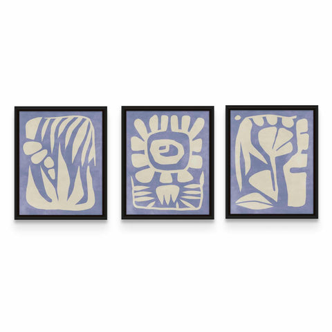 three blue and white artwork pieces hanging on a wall