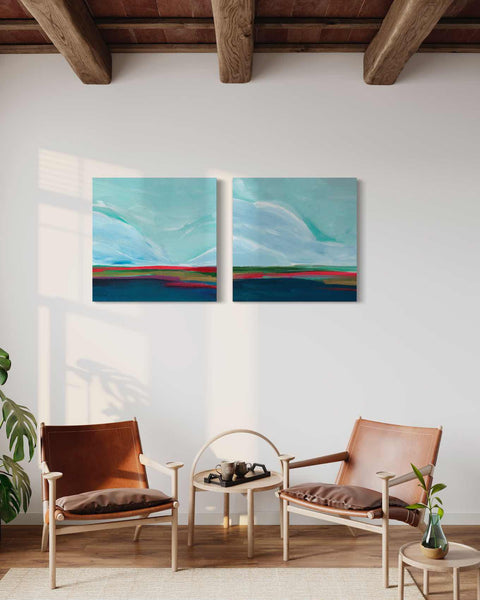 a living room with two paintings on the wall