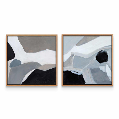 two paintings of black and white are hanging on a wall