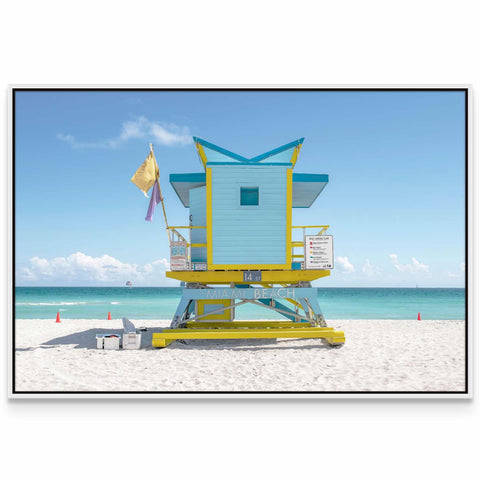 a lifeguard stand on the beach with a flag