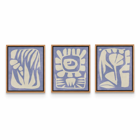 three blue and white paintings hanging on a wall