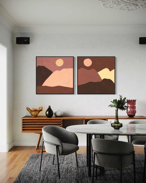 a dining room with two paintings on the wall