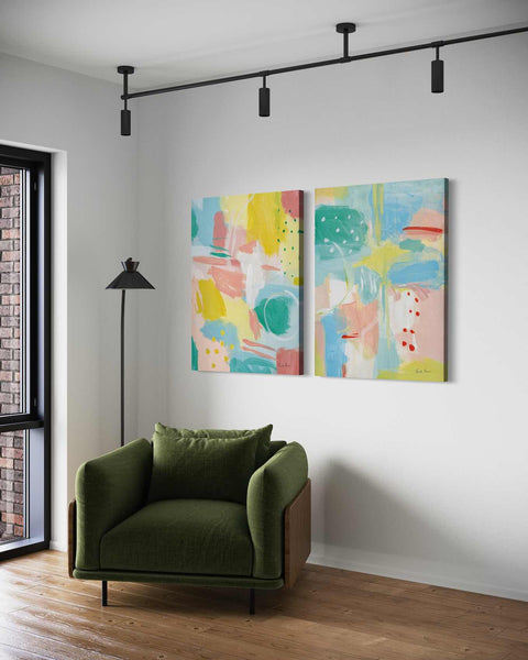 a living room with a green chair and two paintings on the wall