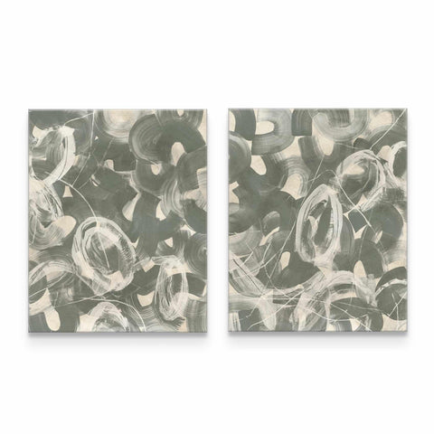 a pair of abstract paintings on a white wall