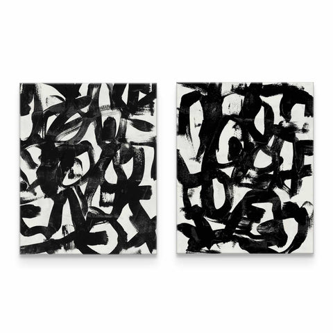 two black and white paintings on a white wall