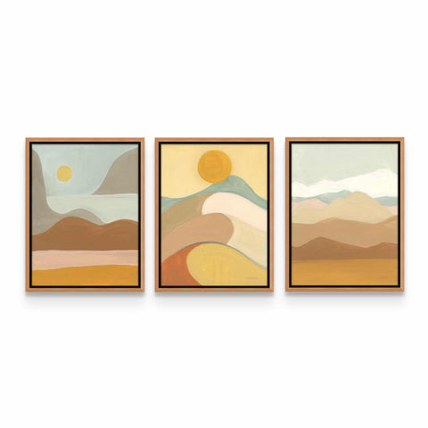 three paintings of mountains and a sun on a white wall