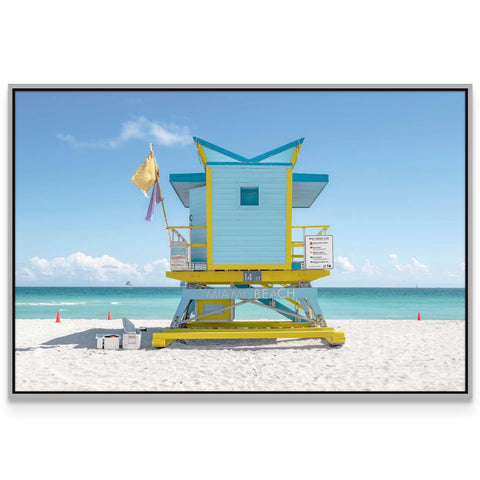 a lifeguard stand on the beach with a flag