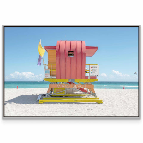 a lifeguard stand on a beach with a blue sky in the background