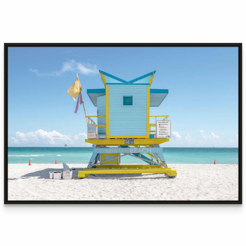 a lifeguard stand on the beach with a flag