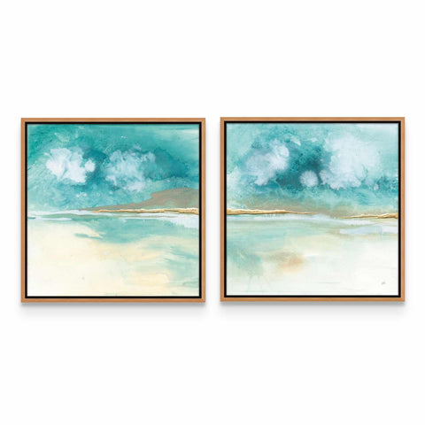two paintings of blue and white clouds hanging on a wall