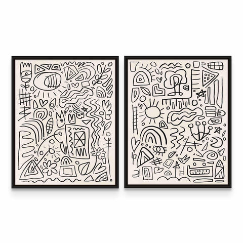 two black and white paintings on a wall