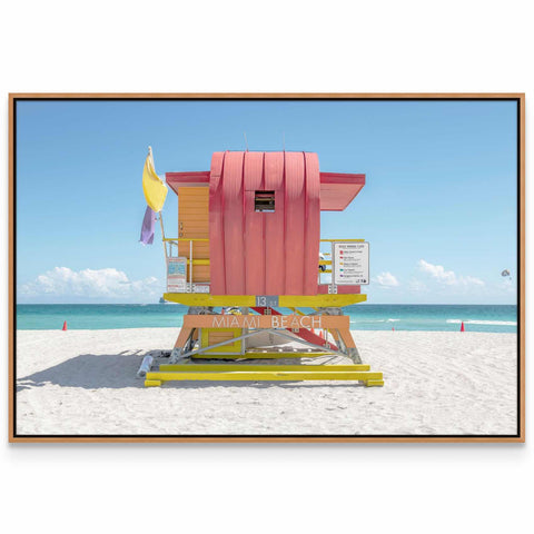 a lifeguard stand on a beach with a blue sky in the background