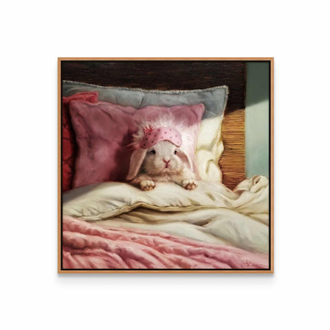 a white dog laying on top of a bed under a pink blanket