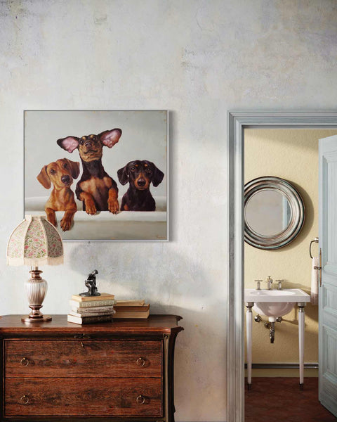 a picture of three dogs hanging on a wall