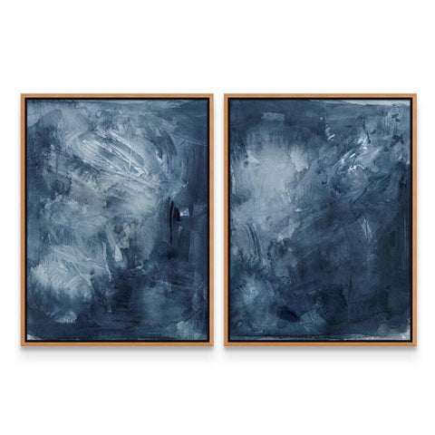 two paintings of blue and white are hanging on a wall