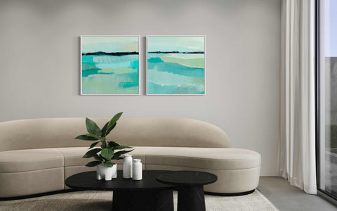 a living room with two paintings on the wall