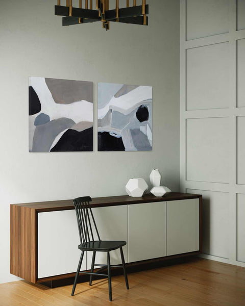 two paintings on the wall of a white room