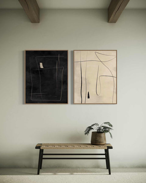 two paintings hang on the wall above a bench