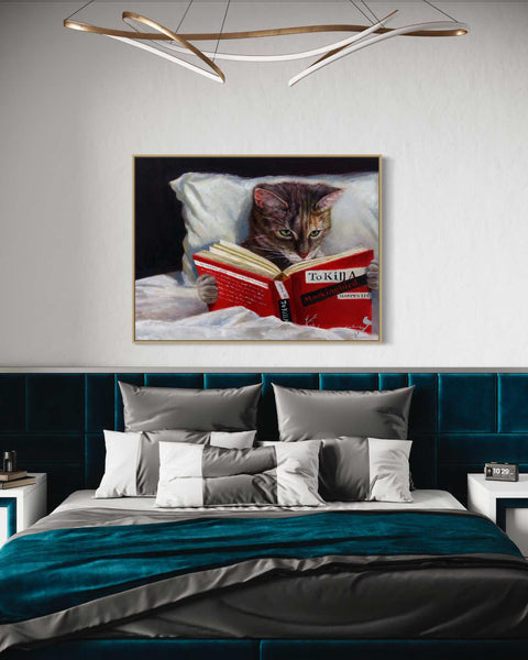a picture of a cat reading a book on a bed