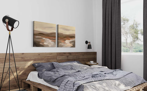 a bed with a wooden headboard and two paintings on the wall