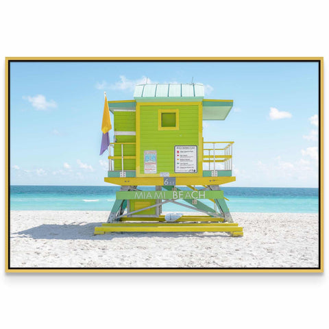 a lifeguard tower on the beach with a blue sky in the background