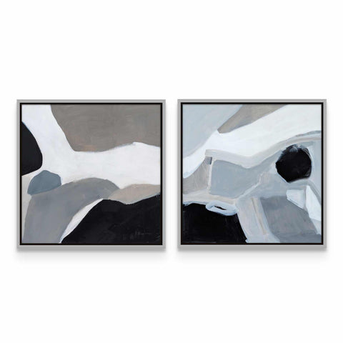 two paintings of black, white and grey on a wall