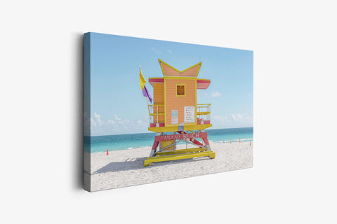 a lifeguard tower on a beach with a blue sky in the background