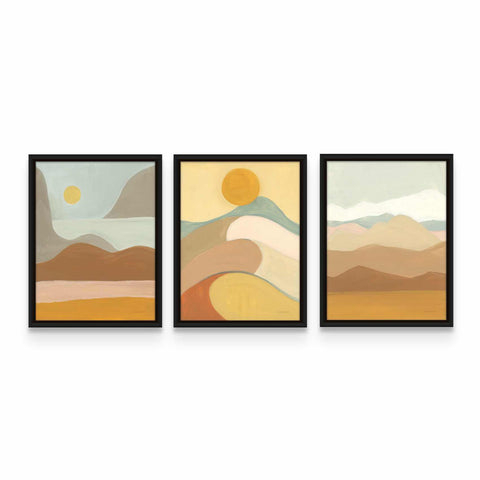 three framed paintings of mountains and a sun
