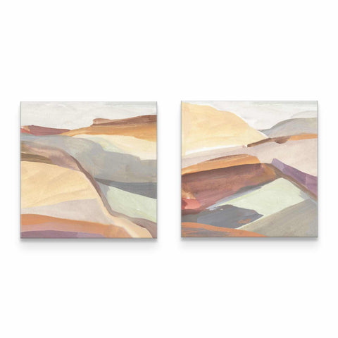 two paintings of mountains on a white wall