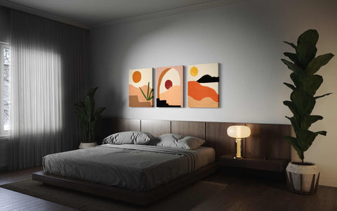 a bedroom with a bed and two paintings on the wall