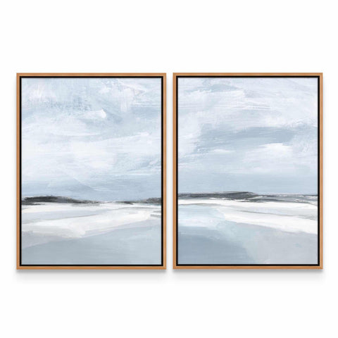 two framed paintings of a beach and sky