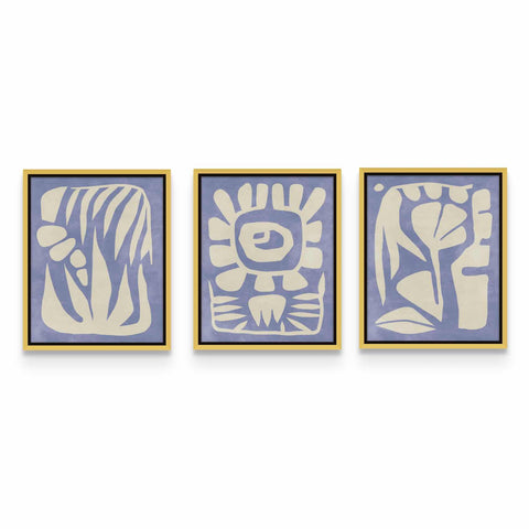 three blue and white paintings hanging on a wall