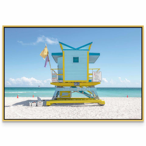 a lifeguard stand on the beach with a flag on it