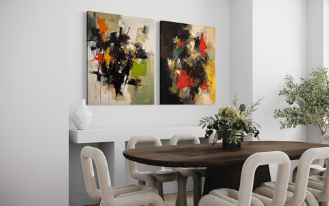 a dining room table with white chairs and paintings on the wall