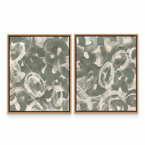 two framed paintings of black and white flowers