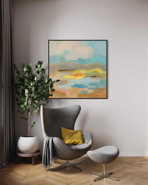 a living room with a chair and a painting on the wall