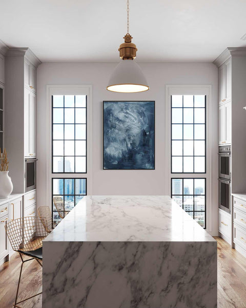 a kitchen with a marble counter top next to a window