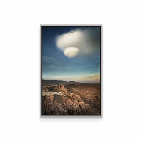 a picture of a desert landscape with a cloud in the sky