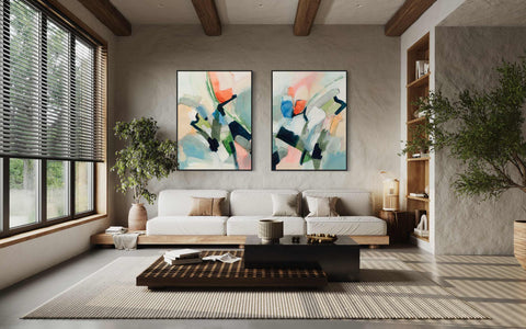 a living room with two paintings on the wall