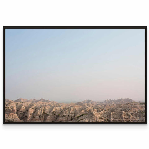 a picture of a mountain range with a blue sky in the background