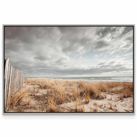 a picture of a beach with a wooden fence