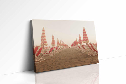 a row of beach chairs sitting on top of a sandy beach