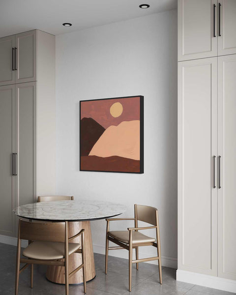 a table and chairs in a room with a painting on the wall
